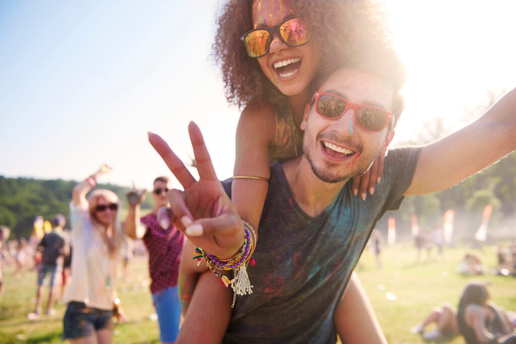 People having fun at a festival. They have ear protection. So they can enjoy the moment without worries.