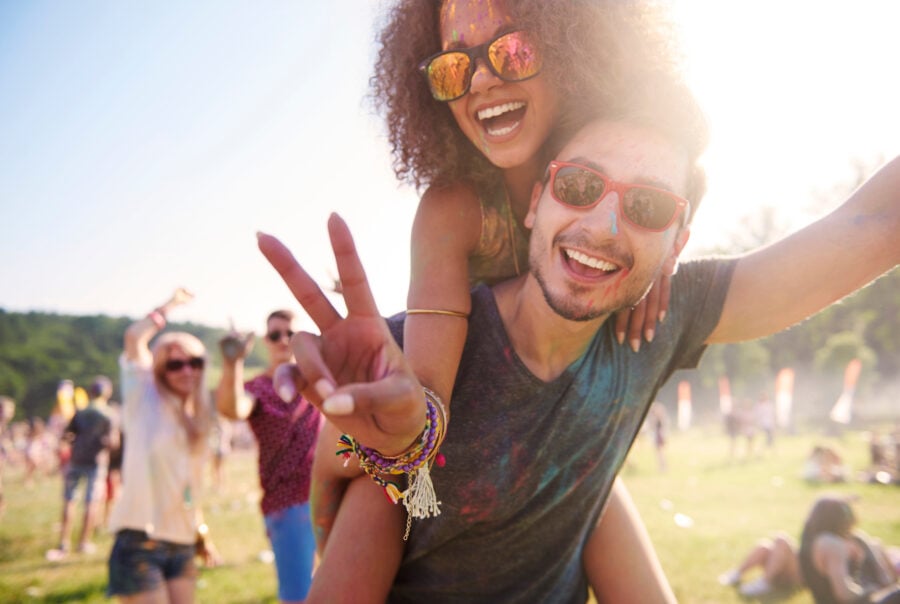 People having fun at a festival. They have ear protection. So they can enjoy the moment without worries.